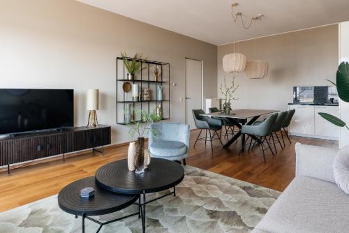 a living room with a couch and a table at BizStay Harbour IV in Scheveningen