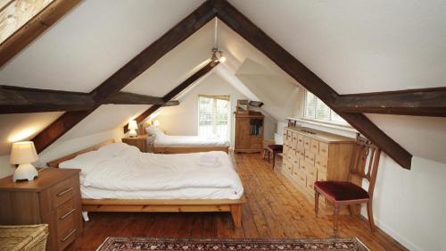 a bedroom with two beds in a attic at Holly Tree Lodge in Nicholaston