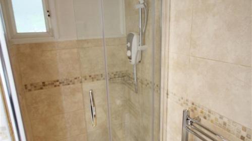 a shower with a glass door in a bathroom at Redcliffe Apartments I in Bishopston