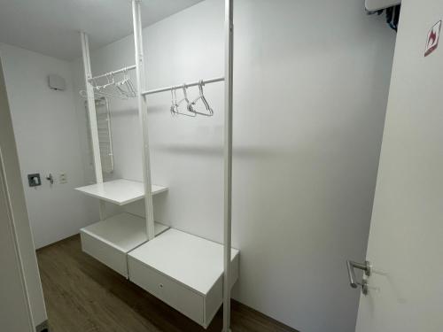 a room with a white closet with two shelves at Casa 47 in Eupen
