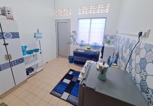 a kitchen with blue and white tiles on the wall at 611 Navy House Seremban Homestay Seremban Town in Seremban