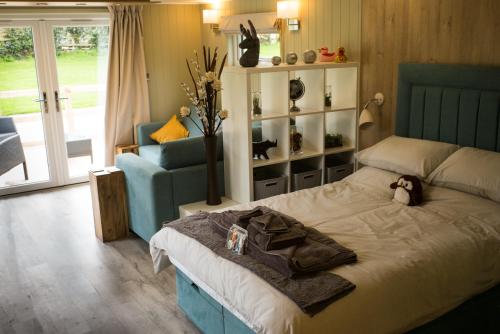 a bedroom with a bed with a stuffed animal on it at Sutton Cabins in Stowey