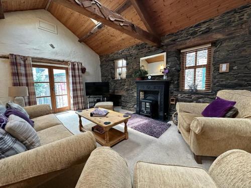 a living room with couches and a fireplace at Bakestones - Central Location with Free Integral Private Parking in Ambleside