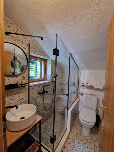 a bathroom with a toilet and a sink and a shower at Home sweet home in Postira