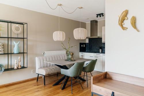 a kitchen and dining room with a table and chairs at BizStay Harbour IV in Scheveningen