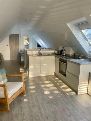 una cocina con fregadero y estufa horno superior en Cosy accommodation, easy walk to beach!, en Barton-on-Sea