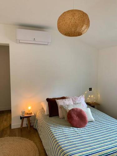 une chambre avec un lit avec des oreillers dessus dans l'établissement La Rose Trémière, à Parentis-en-Born