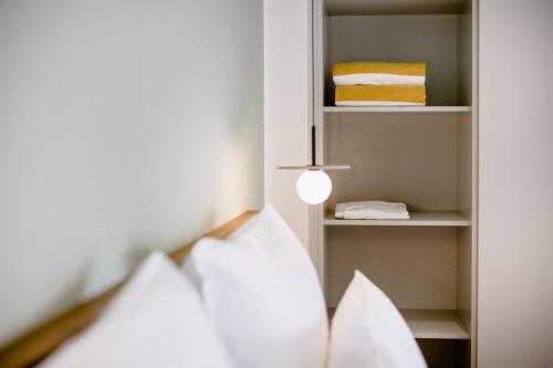 a bedroom with a bed and a light and shelves at THE FLAG HOTEL Marbella, Estepona Adult Recommended in Estepona