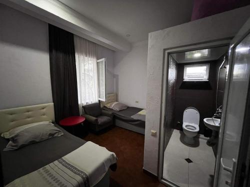 a small room with a bed and a bathroom at Family Hotel Keti in K'obulet'i