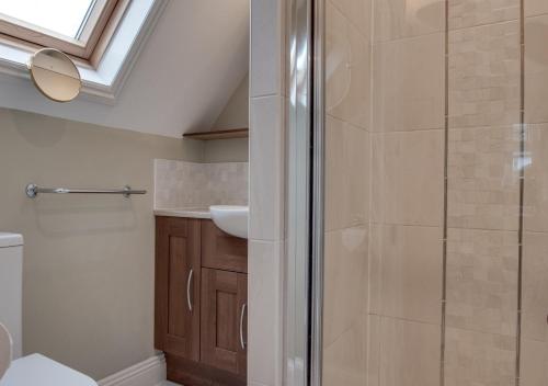 a bathroom with a shower and a sink at The Orchard in Seaton