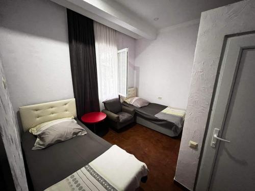 a small room with a bed and a chair at Family Hotel Keti in Kobuleti