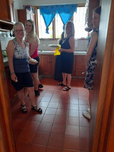 a group of women standing in a kitchen at El Paraiso in Puerto Ayora
