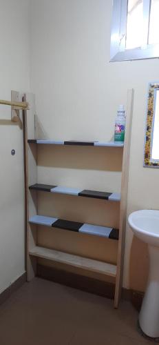 a staircase in a room with a toilet and a sink at Yogi Home Stay Near Freetown Airport in Freetown