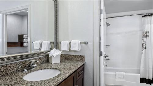 a bathroom with a sink and a mirror at Residence Inn by Marriott San Antonio SeaWorld / Lackland in San Antonio