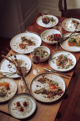a table with plates of food and glasses of wine at Château De Razay in Céré-la-Ronde