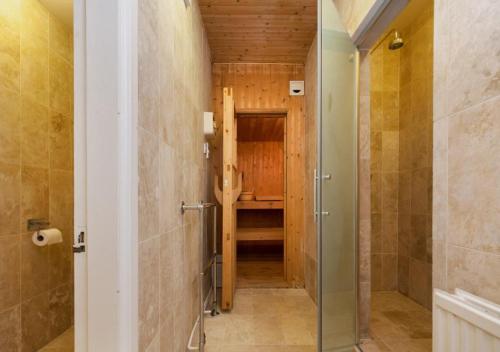 a bathroom with a walk in shower and a walk in closet at Wolborough House in Brixham