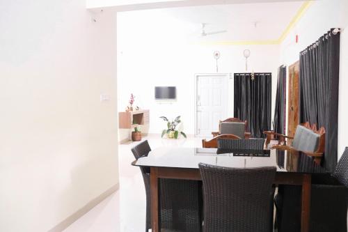 a dining room with a table and chairs at Coorg Nature Breeze home stay in Madikeri