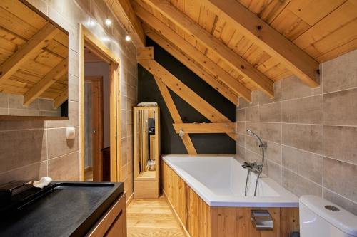 a bathroom with a sink and a bath tub at chalet la traverse in Allemont