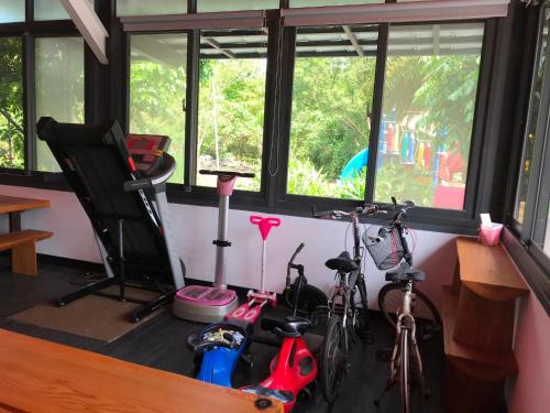 a room with bikes parked in a room with windows at The Tiles Garden Yilan B&B in Dongshan