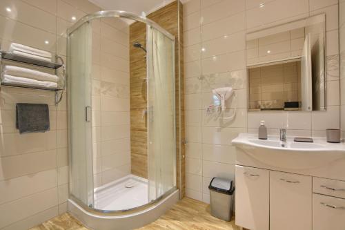 y baño con ducha y lavamanos. en Apartamenty w Bieszczadzkim Horyzoncie, en Ustrzyki Dolne