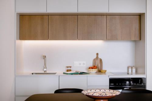 a kitchen with wooden cabinets and a counter top at THE FLAG HOTEL Marbella, Estepona Adult Recommended in Estepona