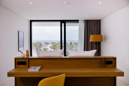 a bedroom with a desk and a window at THE FLAG HOTEL Marbella, Estepona Adult Recommended in Estepona