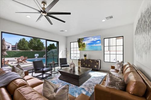 a living room with a couch and a ceiling fan at Casa Blanca luxury Villa Private pool sleeps 30! in Hurricane