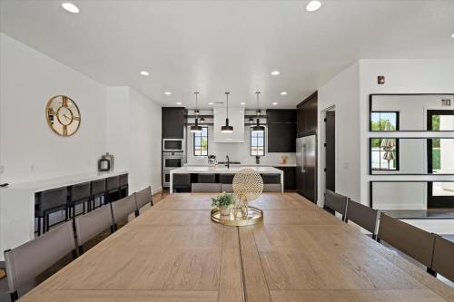 a dining room and kitchen with a large wooden table at Casa Blanca luxury Villa Private pool sleeps 30! in Hurricane