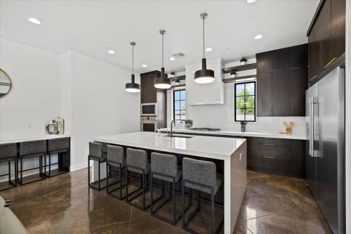 a kitchen with a large white island with bar chairs at Casa Blanca luxury Villa Private pool sleeps 30! in Hurricane