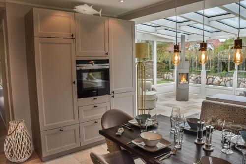 a kitchen with a table and a dining room at Strand und Meer in List