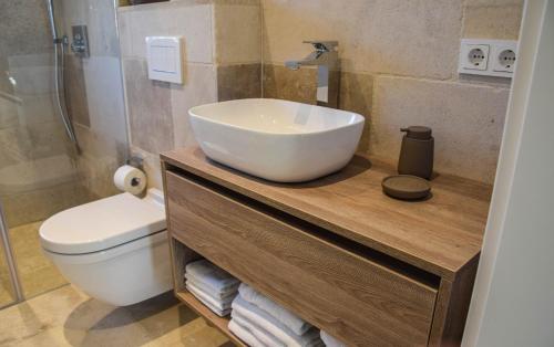 a bathroom with a sink and a toilet at Strand und Meer in List