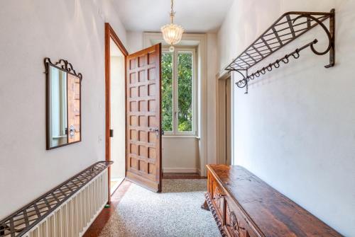 a hallway with a wooden bench and a door at Villa by @ Home Hotel Locarno in Locarno