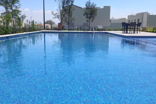 a large swimming pool with blue water at Home dream in Querétaro