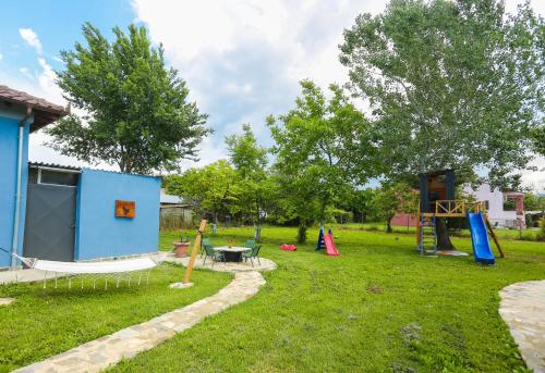 a yard with a playground and a play structure at Pegasus' Glory House in Kavala