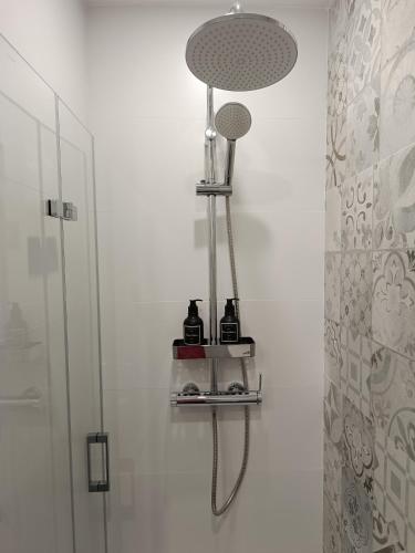 a bathroom with a shower with a shower head at BEACH ALMIRANTE 9 MIJAS Marbella in Sitio de Calahonda