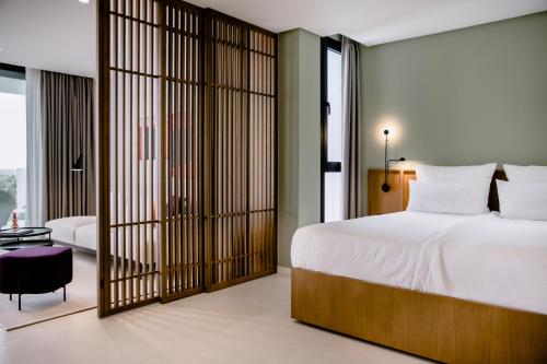 a bedroom with a large white bed and sliding glass doors at THE FLAG HOTEL Marbella, Estepona Adult Recommended in Estepona
