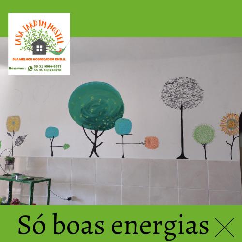 a wall with trees on it with the words so boxes emergency at Casa Jardim Hostel BH - Santa Efigênia - Paraíso in Belo Horizonte