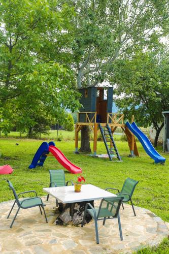 a park with a table and chairs and a playground at Pegasus' Glory House in Kavala