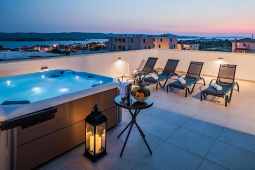 a hot tub on the roof of a house at Villa Gizella in Sveti Filip i Jakov