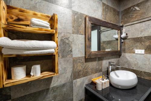 a bathroom with a sink and a mirror at Legend Home Sapa in Sa Pa