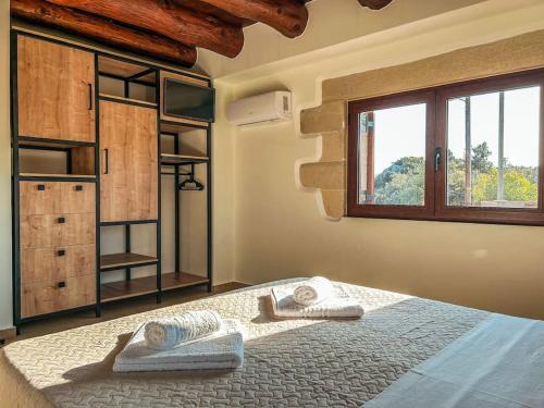 a bedroom with a bed with towels on it at Villa Recluso-3 bd luxury country villa, huge pool with hydromassage, individual bbq & large yard, mountain view in Maláxa