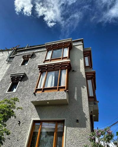a building with windows on the side of it at Maple house ladakh in Leh
