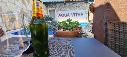 a bottle of wine sitting on a table with a glass at Bed & Breakfast Villa Adriana in Premantura