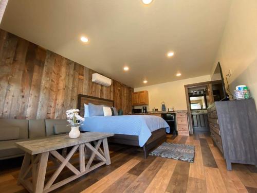 a bedroom with a bed and a couch and a table at Rhodopa Lodge at Yellowstone in Gardiner