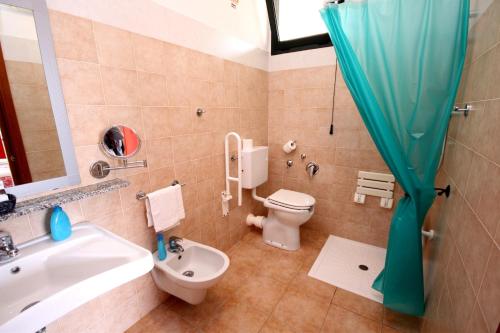 a bathroom with a toilet and a sink and a shower at Hotel Alguer in Alghero