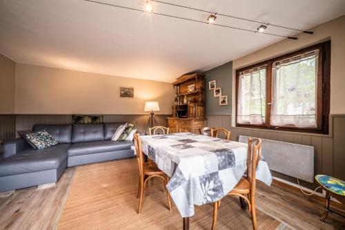 a living room with a table and a couch at Chalet Perce Neige in Châtel