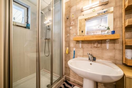 a bathroom with a sink and a shower at Chalet Perce Neige in Châtel