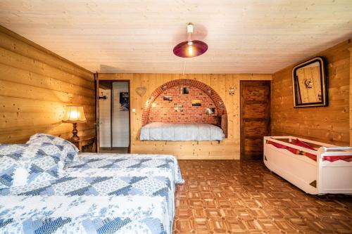 a bedroom with a bed and a brick wall at Chalet Perce Neige in Châtel