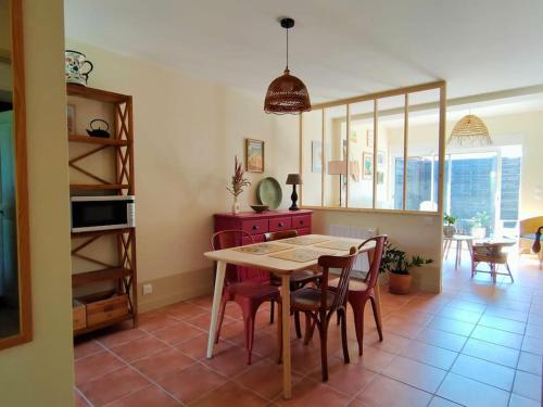 Dolce Vita en Provence في شاتورينارد: مطبخ مع طاولة وكراسي في غرفة