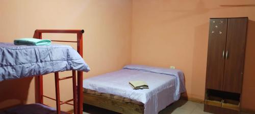 a bedroom with two bunk beds and a cabinet at Alojamiento El Remanso in Puerto Iguazú